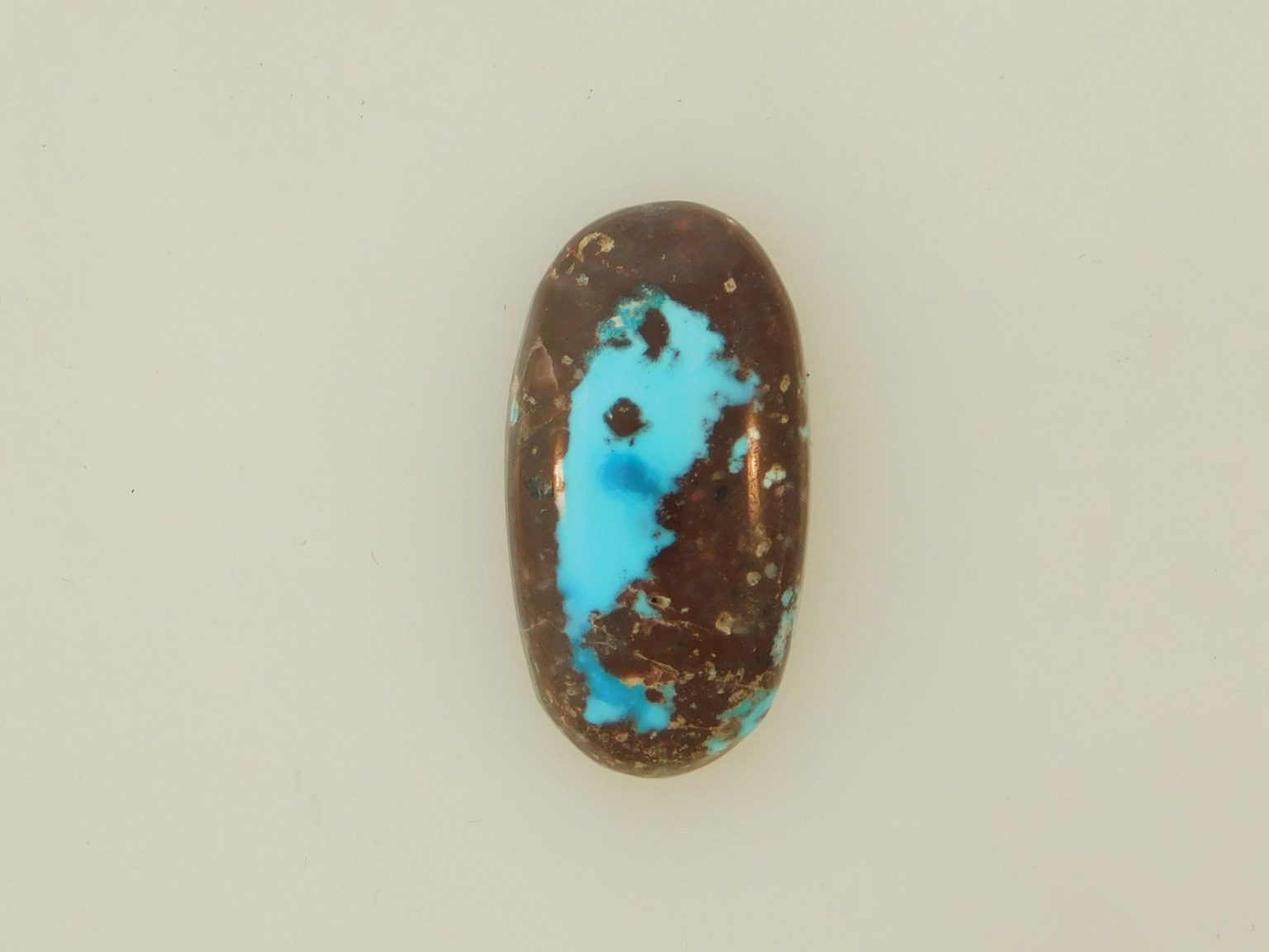 BLUE BISBEE TURQUOISE with blue and dark blue pools in dark brown host 20.5 carats